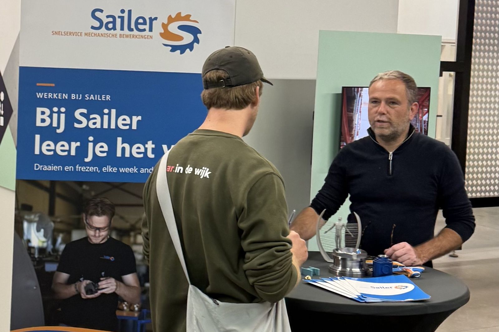 Onze stand op de banenmarkt bij Vidar in Sittard, in gesprek met een bezoeker